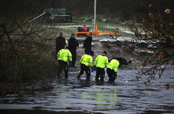 Police investigation teams on the scene after children fell through the ice, at Babbs Mill Park in Kingshurst, Solihull, England, Monday 1 December.  12, 2022. Three young boys who fell through ice that covered a lake in c...