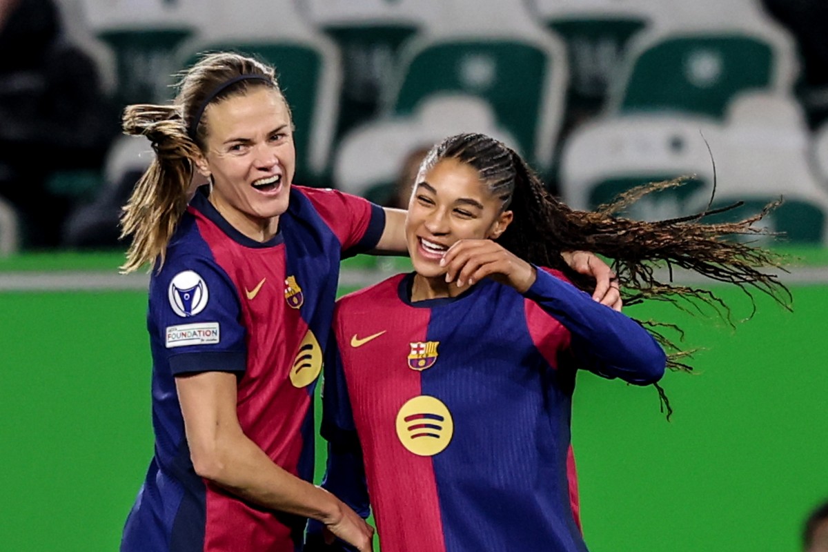 epa11974721 Sydney Schertenleib (R) of Barcelona celebrates with Aitana Bonmati after scoring the 1-4 goal during the UEFA Women's Champions League quarter final soccer match between VfL Wolfsbur ...