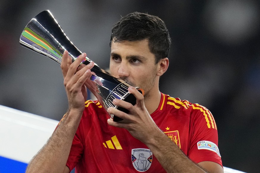 Spain&#039;s Rodri kisses his Best Player of the tournament trophy after the final match between Spain and England at the Euro 2024 soccer tournament in Berlin, Germany, Sunday, July 14, 2024. Spain w ...