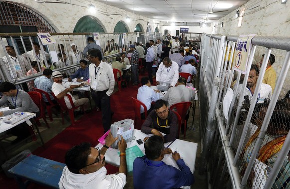 epa07593461 Election officials use electronic voting machines to tally ballots for the Lok Sabha election at a counting center in Bhopal, India, 23 May 2019. The Lok Sabha, the lower house of Parliame ...