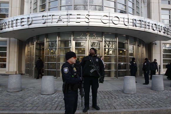 epa04637538 Federal Court police officers stand guard at the entrance of the Federal District Courthouse were three men who arrested for allegedly providing material support to the group ISIS were arr ...