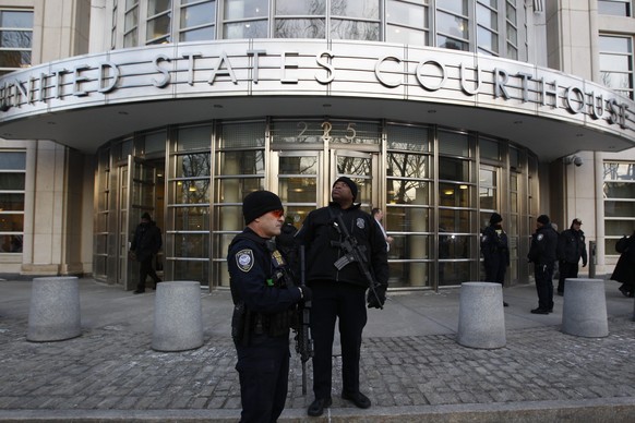 epa04637538 Federal Court police officers stand guard at the entrance of the Federal District Courthouse were three men who arrested for allegedly providing material support to the group ISIS were arr ...