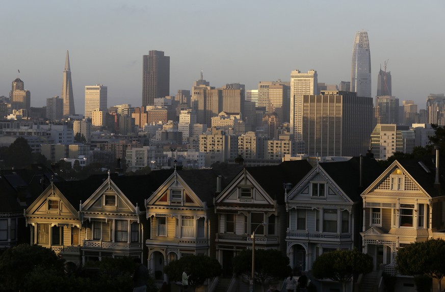 FILE - This July 11, 2017, file photo, shows the skyline beyond a row of Victorian houses in San Francisco. A San Francisco couple has agreed to a $2.25 million legal settlement to the city for illega ...