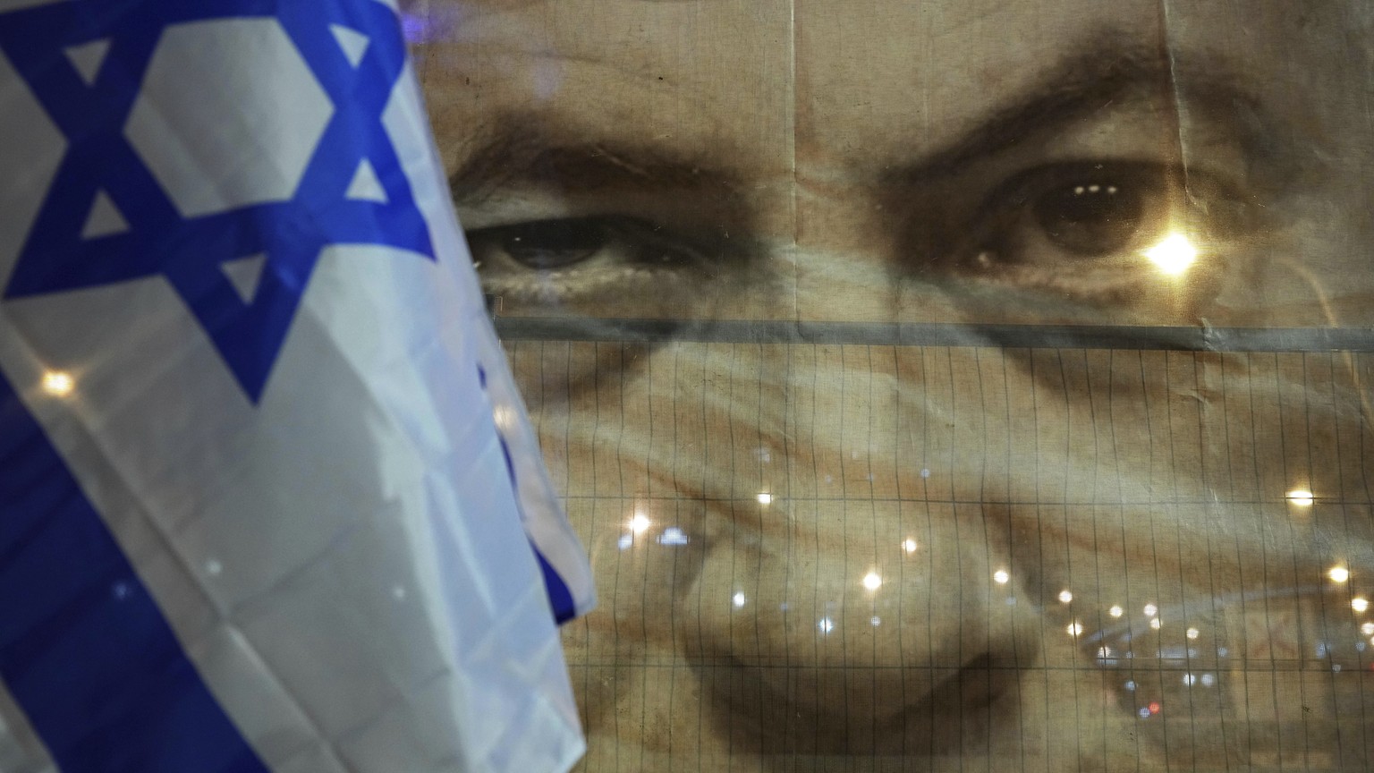 A banner depicting Israeli Prime Minister Benjamin Netanyahu is seenn during a protest against his far-right government, in Tel Aviv, Israel, Saturday, Jan. 21, 2023. Last week, tens of thousands of I ...