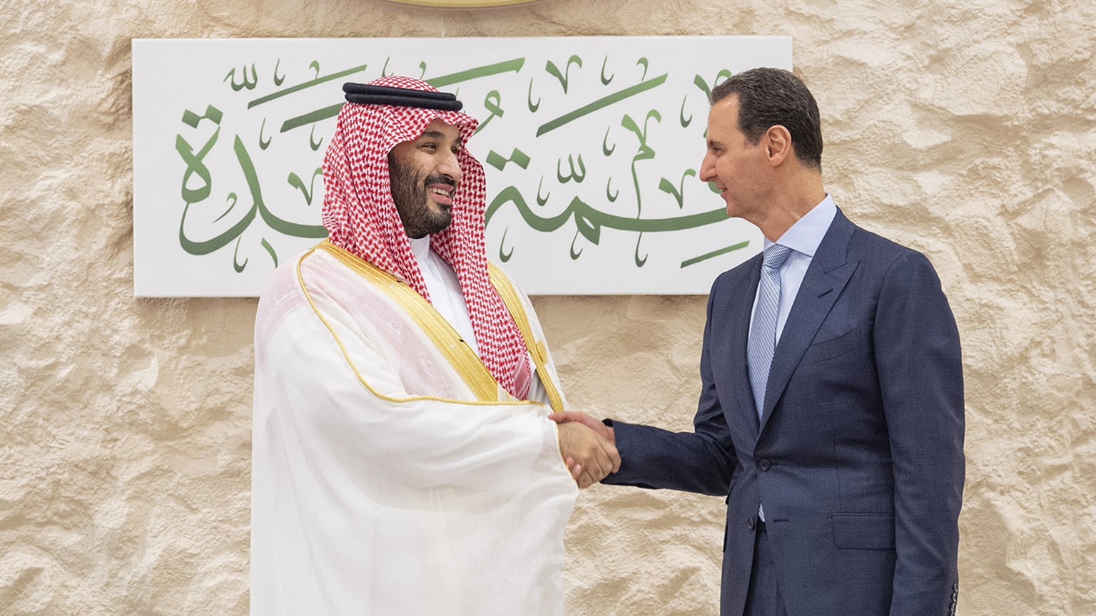 In this photo provided by Saudi Press Agency, SPA, Saudi Crown Prince Mohammed bin Salman, left, greets Syrian President Bashar Assad during the Arab summit in Jeddah, Saudi Arabia, Friday, May 19, 20 ...