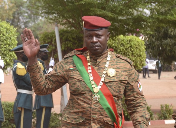 epa09796633 Lieutenant-Colonel Paul-Henri Damiba (C) President of Burkina Faso, waves after his inauguration as the President of the Transition in Ouagadougou, Burkina Faso, 02 March 2022. Following t ...