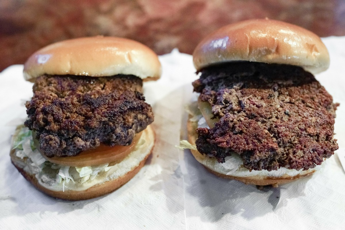 A conventional beef burger, left, is seen Friday, Jan. 11, 2019, next to "The Impossible Burger", right, a plant-based burger containing wheat protein, coconut oil and potato protein among i ...