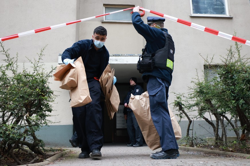 epa11184575 Police officers carry paper bags as they pass under crime-scene tape in front of the entrance to a house where former RAF terrorist Daniela Klette was arrested in Berlin, Germany, 27 Febru ...
