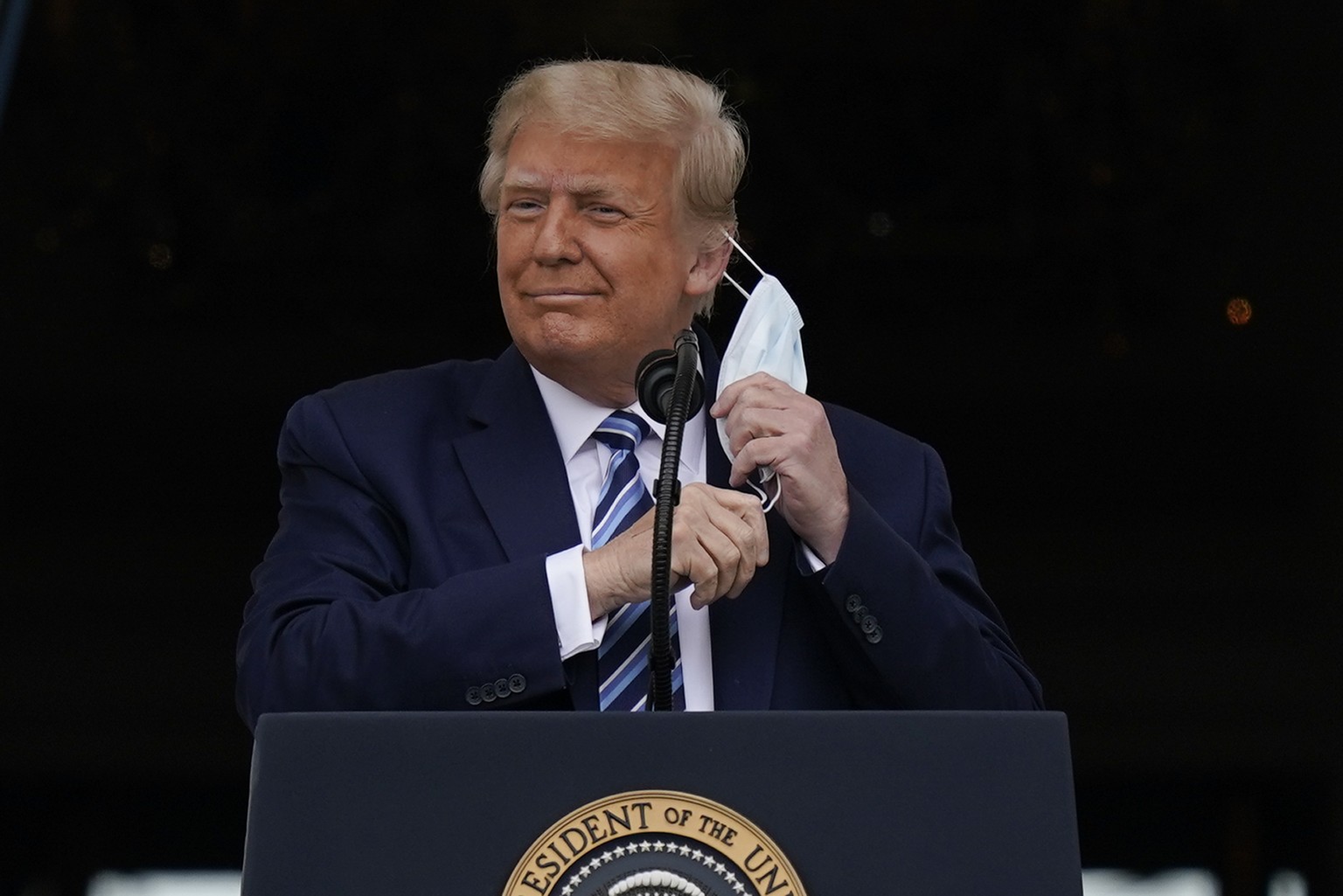 President Donald Trump removes his face mask to speak from the Blue Room Balcony of the White House to a crowd of supporters, Saturday, Oct. 10, 2020, in Washington. (AP Photo/Alex Brandon)
Donald Tru ...