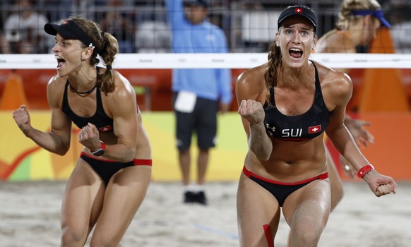 Switzerland&#039;s Joana Heidrich, right, and Nadine Zumkehr celebrate after winning a point during the women&#039;s Round of 16 beach volleyball match against Netherlands&#039;s Marleen van Iersel an ...