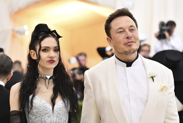 FILE - Grimes, left, and Elon Musk attend The Metropolitan Museum of Art&#039;s Costume Institute benefit gala in New York on May 7, 2018. The Tesla and SpaceX founder tells the New York Post that he  ...
