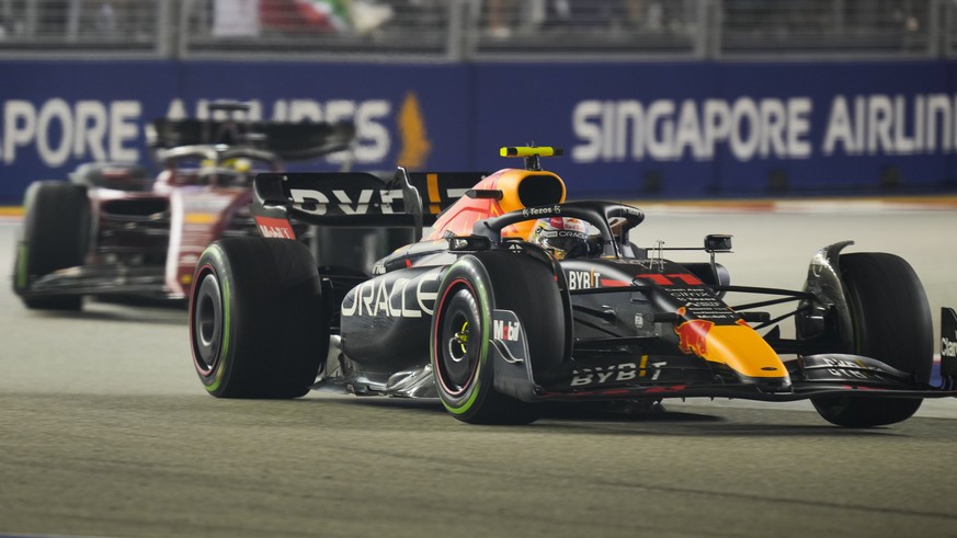 Red Bull driver Sergio Perez of Mexico leads Ferrari driver Charles Leclerc of Monaco during the Singapore Formula One Grand Prix, at the Marina Bay City Circuit in Singapore, Sunday, Oct.2, 2022. (AP ...