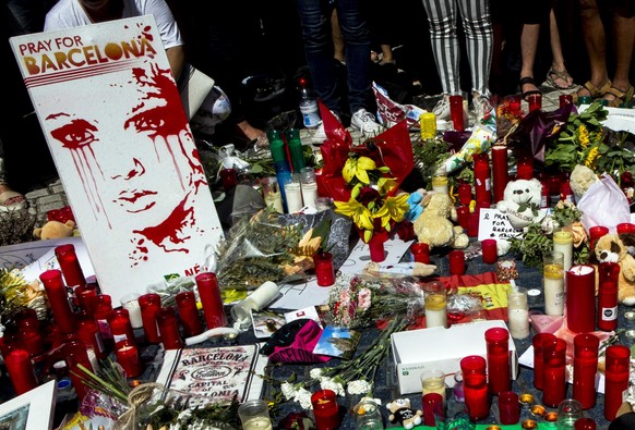 epa06149877 Tributes to victims outside the Liceu Theatre, on the site of a deadly van attack in Barcelona, Spain, 18 August 2017. According to media reports, at least 14 people have died and 130 were ...