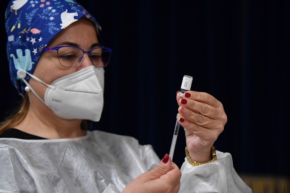 epa09183485 A health worker prepares a dose of the anti-covid-19 vaccine in Salina (Eolie Islands), Sicily Island, Italy, 7 May 2021. The anti Covid mass vaccination plan for the smaller islands start ...