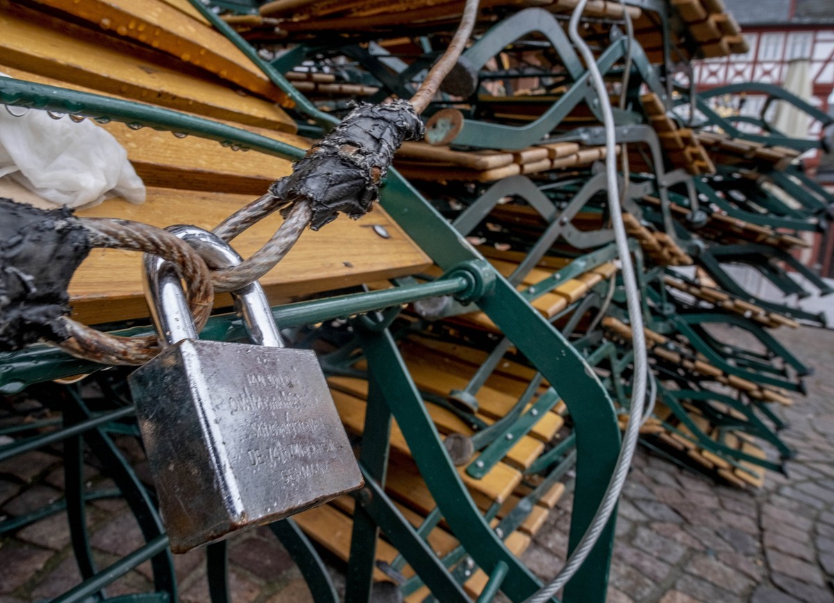 Chairs and tables outside a restaurant are locked at the the Roemerberg square in Frankfurt, Germany, Friday, March 5, 2021. Due to the coronavirus bars and restaurants are still closed. (AP Photo/Mic ...