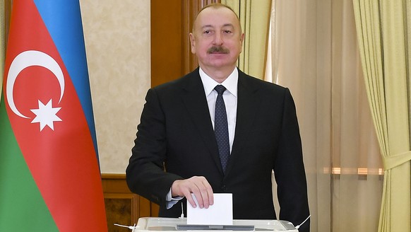 Azerbaijan President Ilham Aliyev casts his ballot during presidential election at a polling station in Khankendi, Karabakh region, Azerbaijan, Wednesday, Feb. 7, 2024. Azerbaijanis are voting Wednesd ...