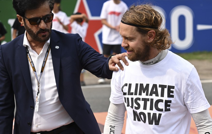 epa10159363 Emirati Mohammed Bin Sulayem, President of FIA, (L) and German Formula One driver Sebastian Vettel of Aston Martin (R) interact ahead of the Formula One Grand Prix of the Netherlands at Ci ...