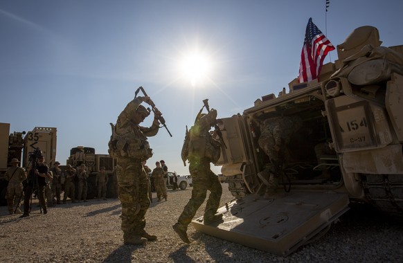 FILE - Crew members penetrate Bradley combat vehicles into a US military base at an undisclosed location in Northeast Syria on November 11, 2019.  Legislation directing President Joe Biden to some 900 U.…