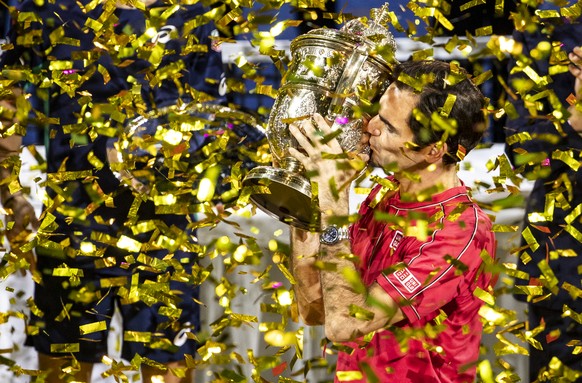 Roger Federer of Switzerland poses with his trophy after defeating Alex De Minaur of Australia after the final match at the Swiss Indoors tennis tournament at the St. Jakobshalle in Basel, Switzerland ...