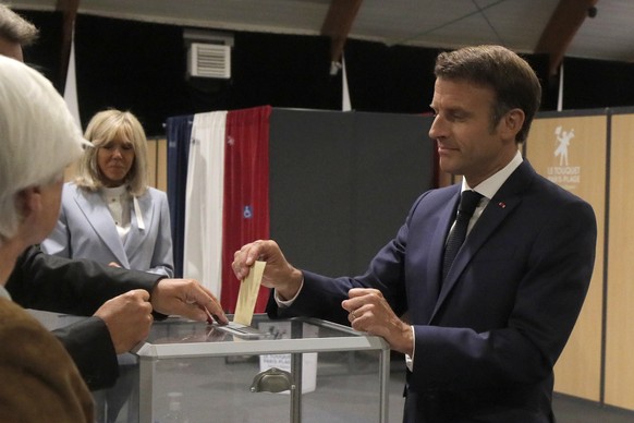 epa10021819 French President Emmanuel Macron casts his ballot in Le Touquet, northern France, 19 June 2022. French voters are going to the polls in the final round of key parliamentary elections that  ...