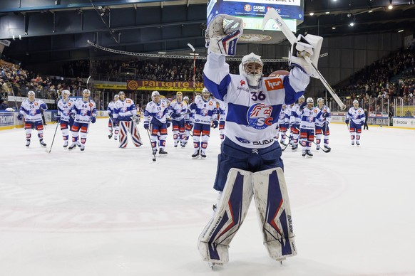 Lions&#039; goaltender Jeffrey Meier and his teammates celebrate after defeating the team of Geneve-Servette, during a National League regular season game of the Swiss Championship between Geneve-Serv ...