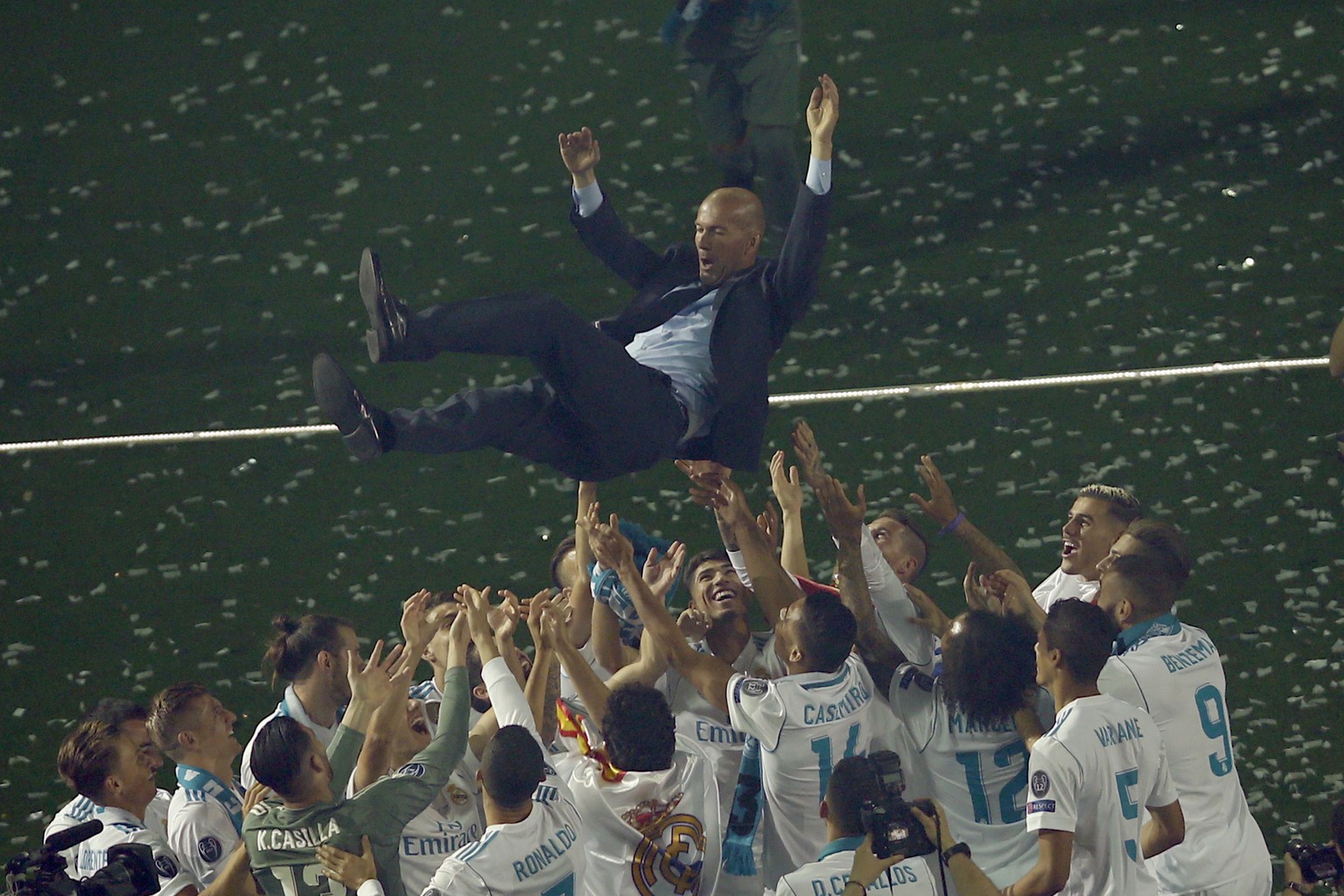 Real Madrid players lift head coach Zinedine Zidane into the air as they celebrate after winning the Champions League final, at the Santiago Bernabeu stadium in Madrid, Spain, Sunday, May 27, 2018. (A ...
