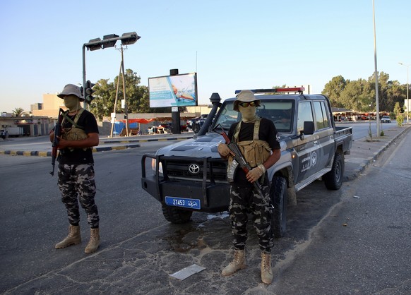 epa10802887 Forces affiliated with the Tripoli-based Government of National Unity (GNU) secure a street in Tripoli, Libya, 16 August 2023. According to the Center for Emergency Medicine, nearly thirty ...