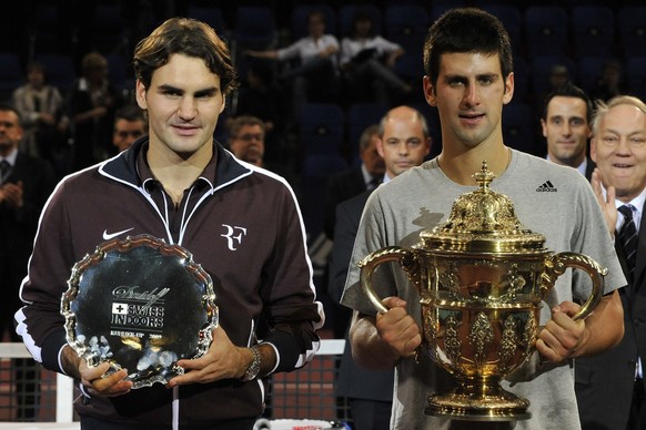 Serbia&#039;s Novak Djokovic, right, poses after winning his final match against Switzerland&#039;s Roger Federer, left, at the Davidoff Swiss Indoors tennis tournament in Basel, Switzerland, Sunday,  ...