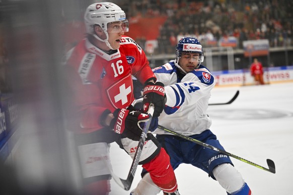 Switzerland&#039;s Dario Wuethrich, left, and Slovakia&#039;s Andrej Krajcovic in action during the friendly icehockey game between Switzerland and Slovakia at the Sportzentrum Arena in Herisau, Switz ...