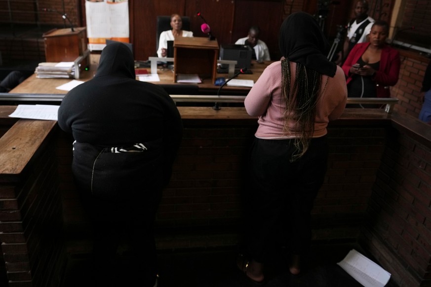 Two women appear in Boksburg Magistrate Court, east of Johannesburg, South Africa, Monday, Sept. 21, 2026, in connection with one of a series of killings of women in Johannesburg. (AP Photo/Themba Had ...
