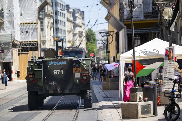 A Piranha tank belonging to the Geneva police is patrolling the city center ahead of demonstrations against the G7 summit in nearby Evian, in Geneva, Switzerland, Saturday, June 13, 2026. Demonstratio ...
