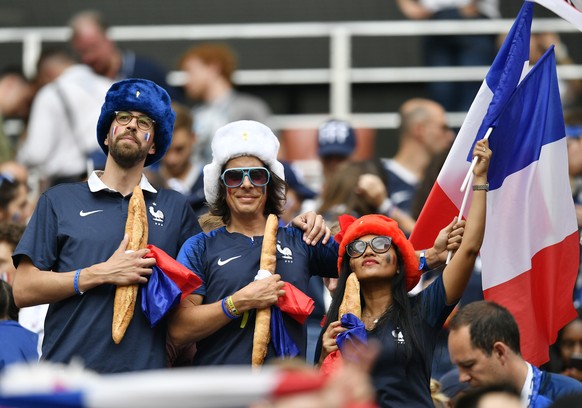 France fans pose with French flags and baguettes prior to the final match between France and Croatia at the 2018 soccer World Cup in the Luzhniki Stadium in Moscow, Russia, Sunday, July 15, 2018. (AP  ...