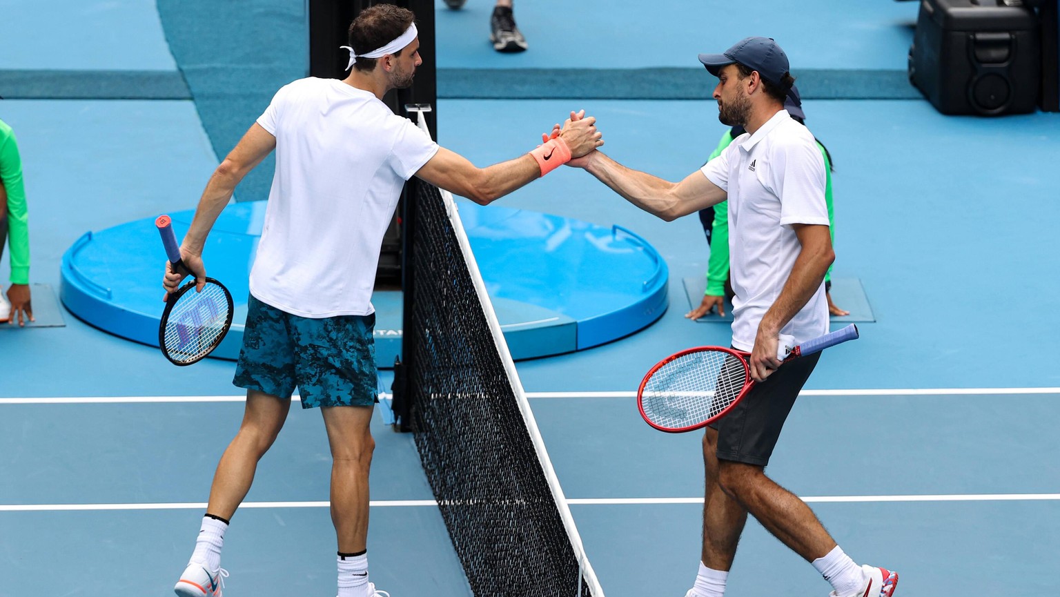 210216 -- MELBOURNE, Feb. 16, 2021 -- Grigor Dimitrov L of Bulgaria greets Aslan Karatsev of Russia after their men s singles quarterfinal match at Australian Open in Melbourne Park, in Melbourne, Aus ...
