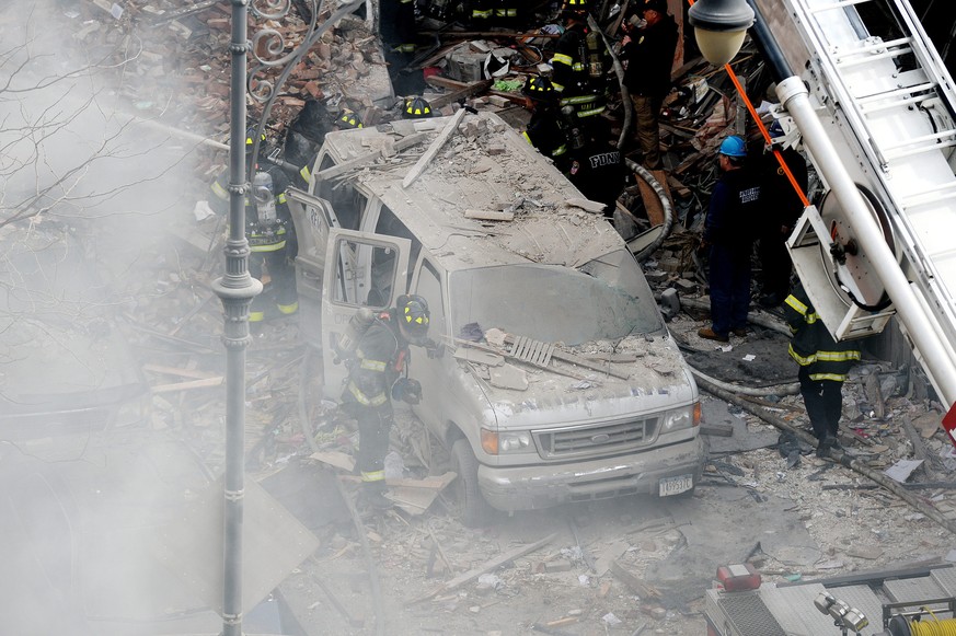 epa04121818 A view firefighters on the scene where a group of buildings were damaged by fire and a possible explosion in New York, New York, USA, 12 March 2014. The cause of the explosion, as well as reports of any injuries, had not yet been determined.  EPA/JUSTIN LANE