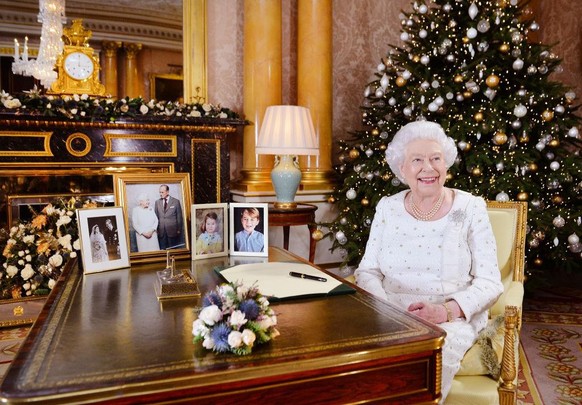 2017 LONDON, UNITED KINGDOM - In this undated image supplied by Sky News, Queen Elizabeth II sits at a desk in the 1844 Room at Buckingham Palace, after recording her Christmas Day broadcast to the Co ...