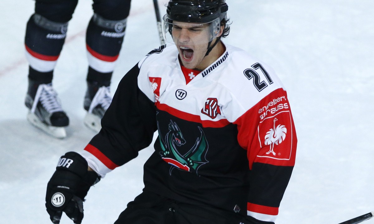 Fribourg's Yannick Rathgeb, celebrats his winning goal during the ice hockey Champions League match 1/8 Final between HC Fribourg-Gotteron and KalPa Kuopio of Finland, in Fribourg, Switzerland, T ...