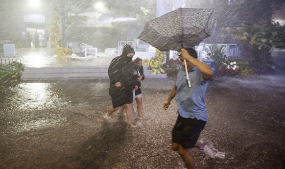 epa09442067 People navigate heavy rains and flooded walkways at the Billie Jean King National Tennis Center as the remnants of Hurricane Ida hit the area in Flushing Meadows, New York, USA, 01 Septemb ...