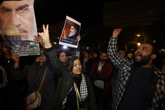epa12802477 A protester holds up a picture of the late Hezbollah leader, Hassan Nasrallah, during a pro-Iranian rally protesting against US-Israeli attacks on Iran in Tunis, Tunisia, 07 March 2026. Th ...