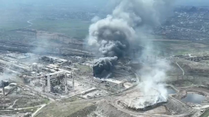 epa09896967 A frame grab from an undated handout drone video first published by DPR militia commander Alexander Khodakovsky and made available by the Mariupol City Council shows smoke rising from the  ...