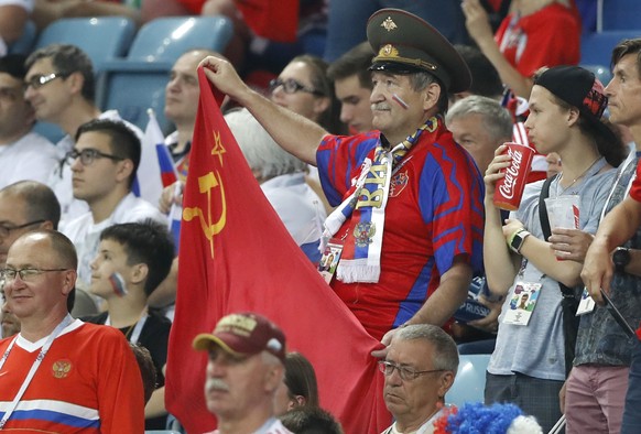 A Russian fan holds a Soviet flag prior the quarterfinal match between Russia and Croatia at the 2018 soccer World Cup in the Fisht Stadium, in Sochi, Russia, Saturday, July 7, 2018. (AP Photo/Darko B ...