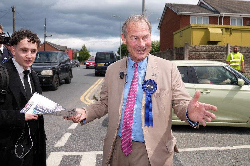 Britain's leader of Restore Britain Rupert Lowe speaks to a members of the public during the by-election in Makerfield, England, Thursday, June 18, 2026.(AP Photo/Jon Super)
Britain Pivotal Elect ...