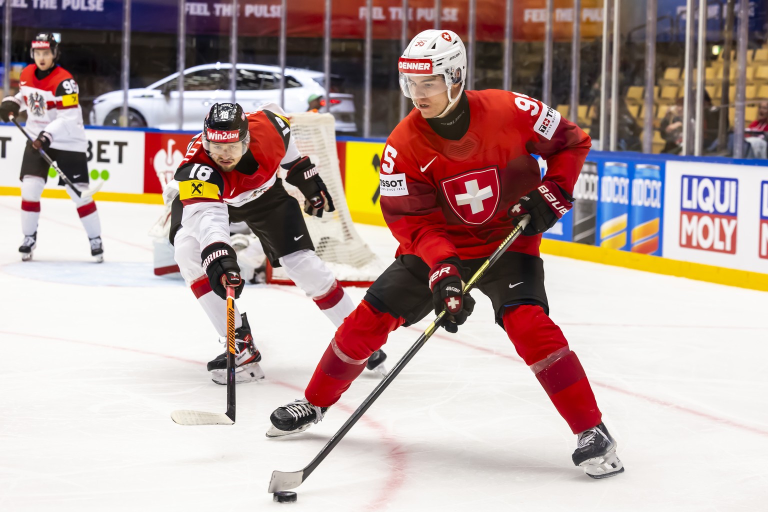 Austria&#039;s defender Paul Stapelfeldt, left, vies for the puck with Switzerland&#039;s forward Tyler Moy, right, during the IIHF 2025 World Championship quarter final game between Switzerland and A ...