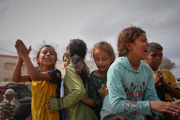 Palestinians celebrate following the announcement that Israel and Hamas have agreed to the first phase of a peace plan to pause the fighting, in Khan Younis, southern Gaza Strip, Thursday, Oct. 9, 202 ...