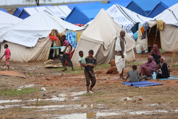 epa11494677 People walk near their tents at a camp for people displaced due to fighting in Sinja town of Sennar State, established at Al-Huri, Gedaref city, eastern Sudan, 24 July 2024. According to U ...