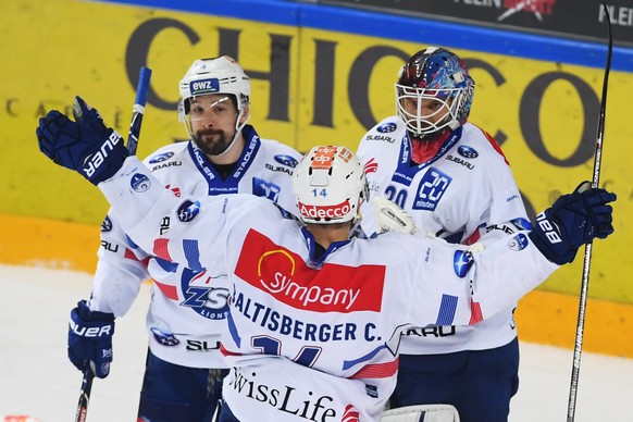 Zurich&#039;s goalkeeper Lukas Flueeler, right, celebrates the 0-1 victory with Zurich&#039;s player Patrick Geering, left, and Zurich&#039;s player Chris Baltisberger, center, during the first match  ...