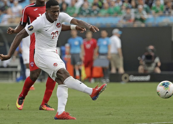 Canada&#039;s Jonathan David (20) kicks the ball past Cuba&#039;s Daniel Morejon (5) for a goal during the second half of a CONCACAF Golf Cup soccer match in Charlotte, N.C., Sunday, June 23, 2019. (A ...