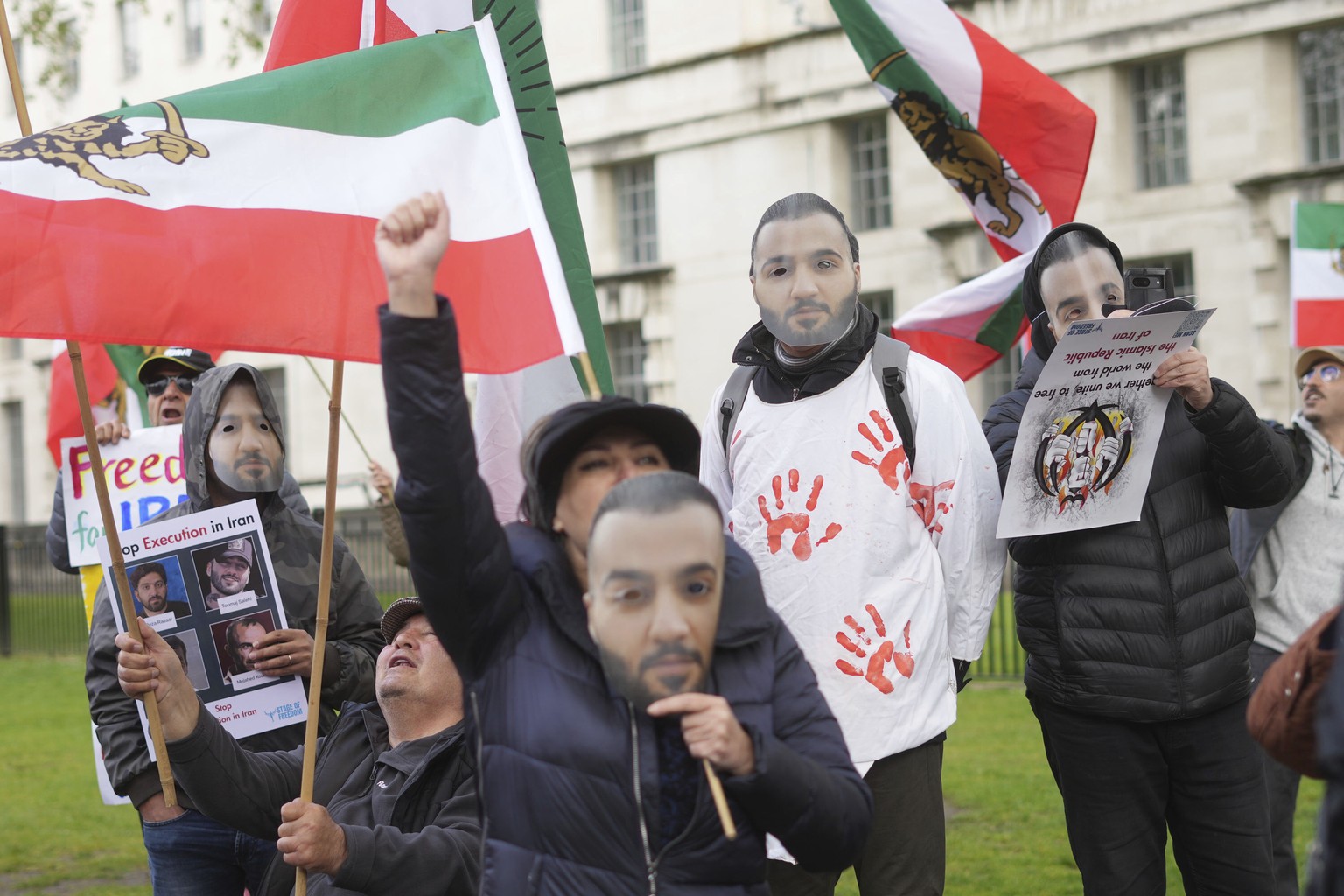 People attend a protest against Iranian rapper Toomaj Salehi being sentenced to death in Iran, opposite Downing Street, in Whitehall, London, Sunday April 28, 2024. A rapper in Iran who came to fame o ...