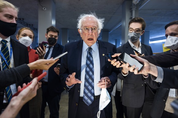 epaselect epa09559630 Independent Senator from Vermont Bernie Sanders (C) speaks to the media as we walks to the Senate floor of the US Capitol in Washington, DC, USA, 02 November 2021. Speaker of the ...