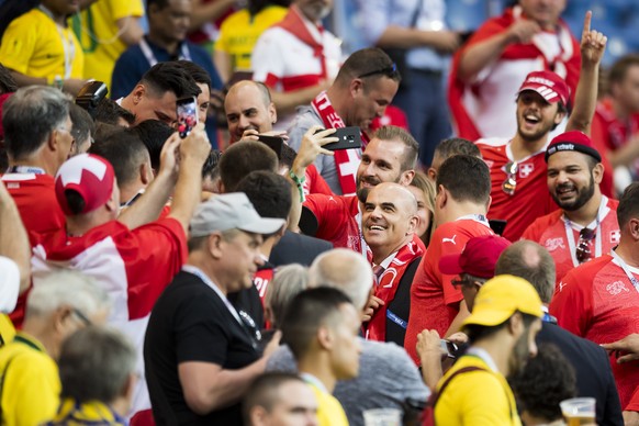 Swiss Federal President Alain Berset, center, smiles surrounded by fans from Switzerland during the FIFA soccer World Cup 2018 group E match between Switzerland and Brazil at the Rostov Arena, in Rost ...