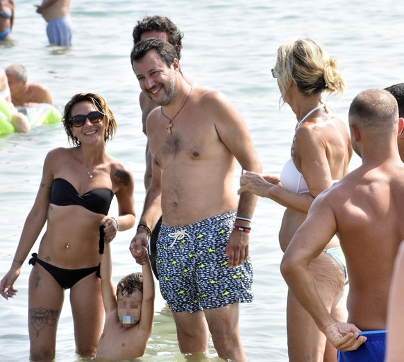 epa08576902 League party leader Matteo Salvini with people on the beach of Papeete, the seaside resort of Milano Marittima near Ravenna, Italy, where he resigned at the beginning of August last year a ...